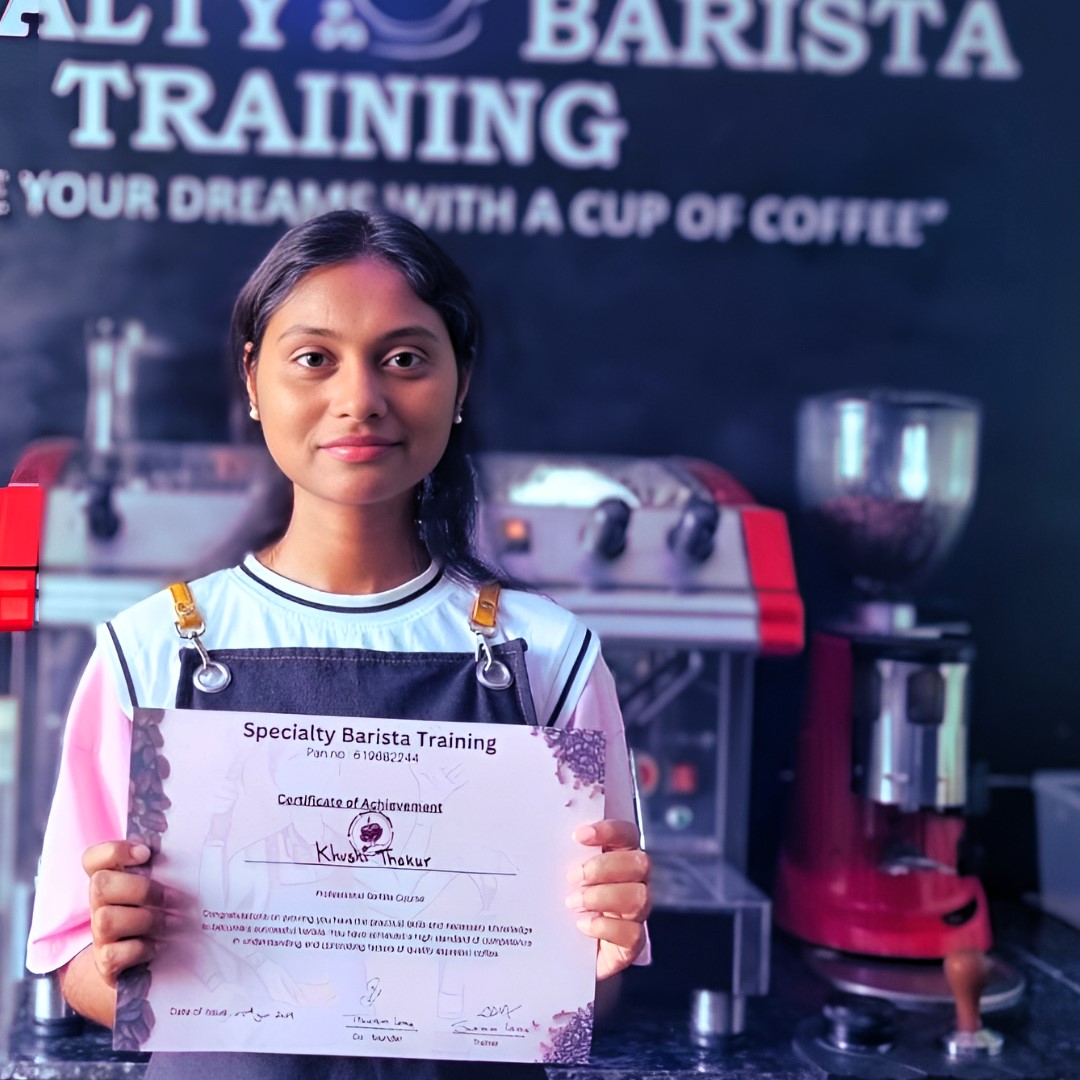 A close-up of a barista creating intricate latte art in a cup.